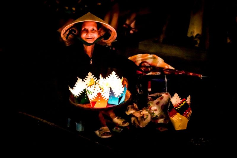 Vietnamese lady with lights in street market