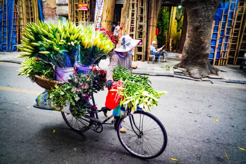Lady with flower bicycle in Vietnam